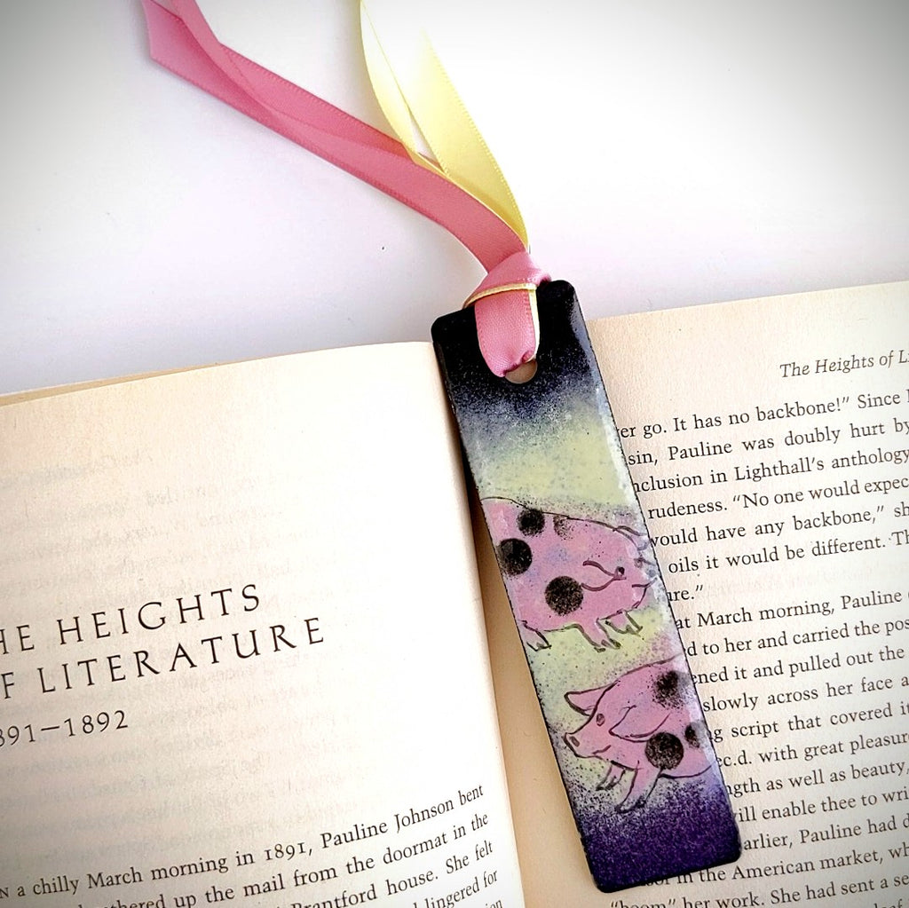 lifestyle pic of Pigs design enamel bookmark by Margot Page