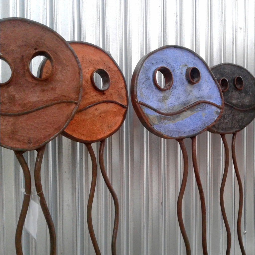 assorted Happy Pills by Mark Clark, steel and concrete sculpture.