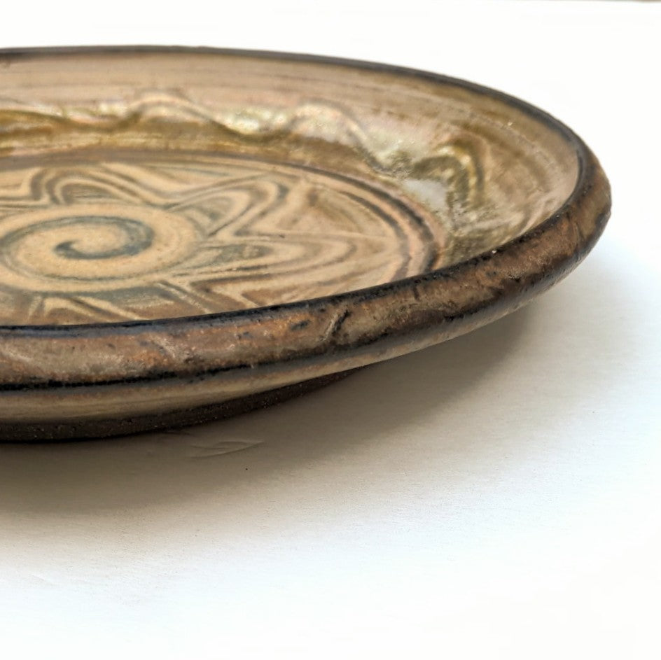 Hand crafted, wheel-thrown plate by Canadian potter Wayne Cardinalli. side view