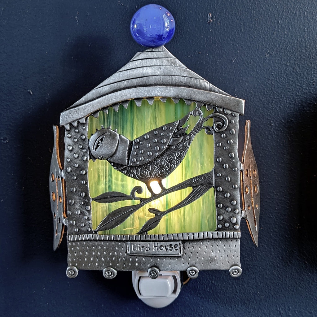 Bird House pewter night light by Leandra Drumm, night time illuminated view