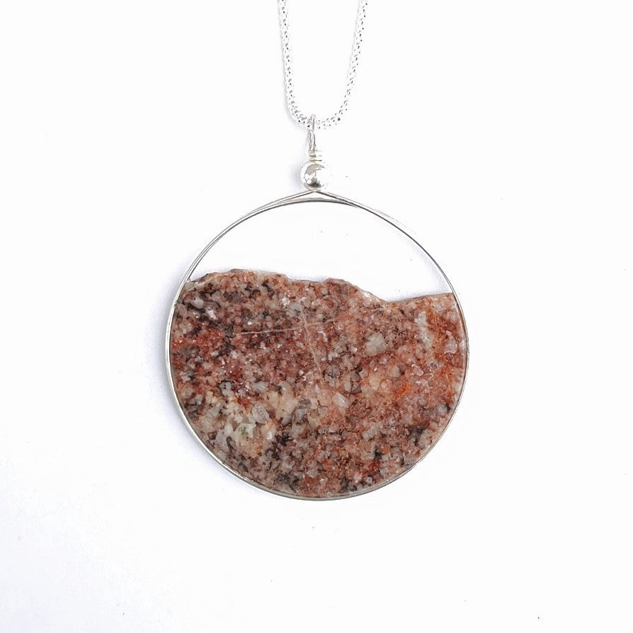 Natural side of solid granite disc jewellery, A slice of the North, by Wendy Stanwick.