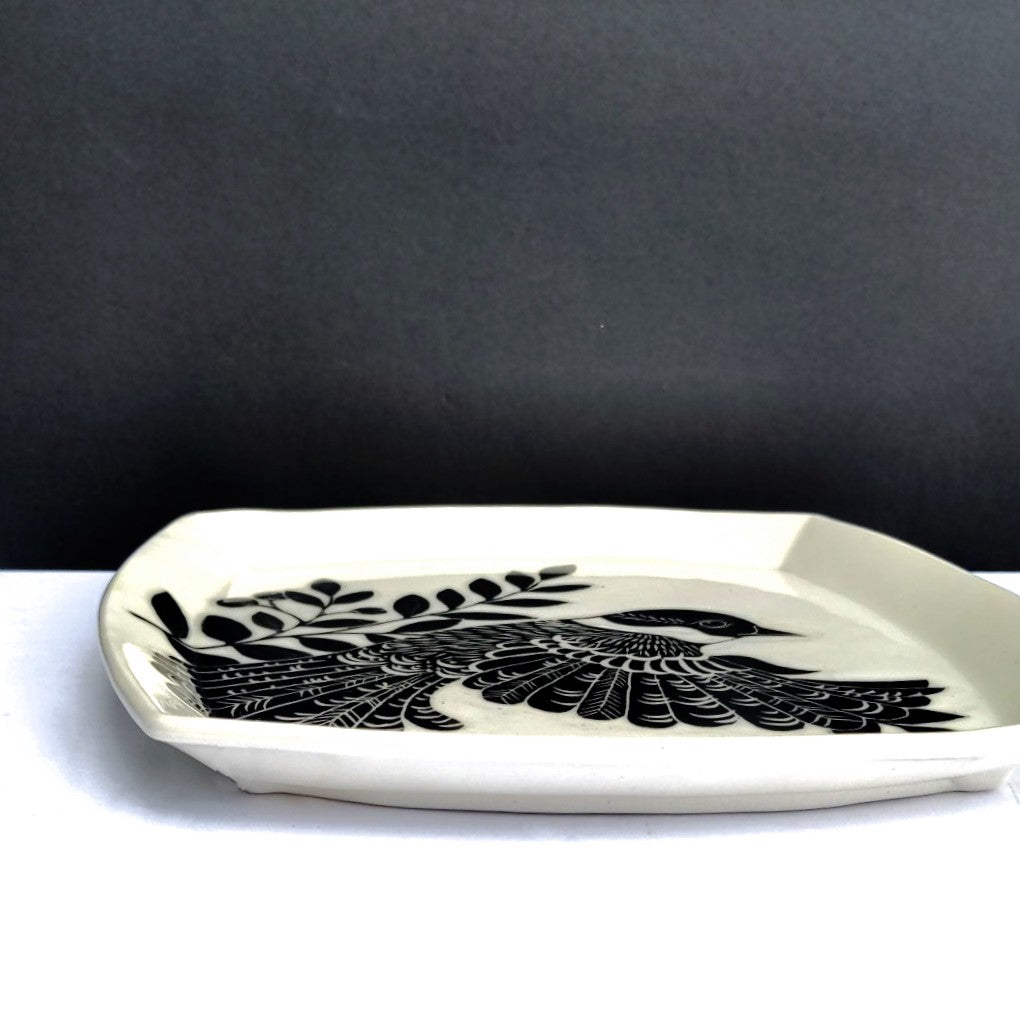 side view of Square rimmed plate, bird design carved on white clay, pottery by Amanda Kerr