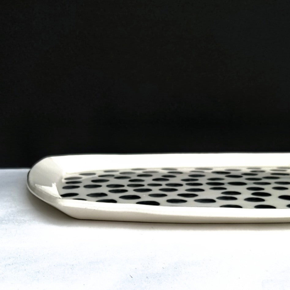 Graphic black and white serving platter, hand made pottery by Juliet Promintz side view