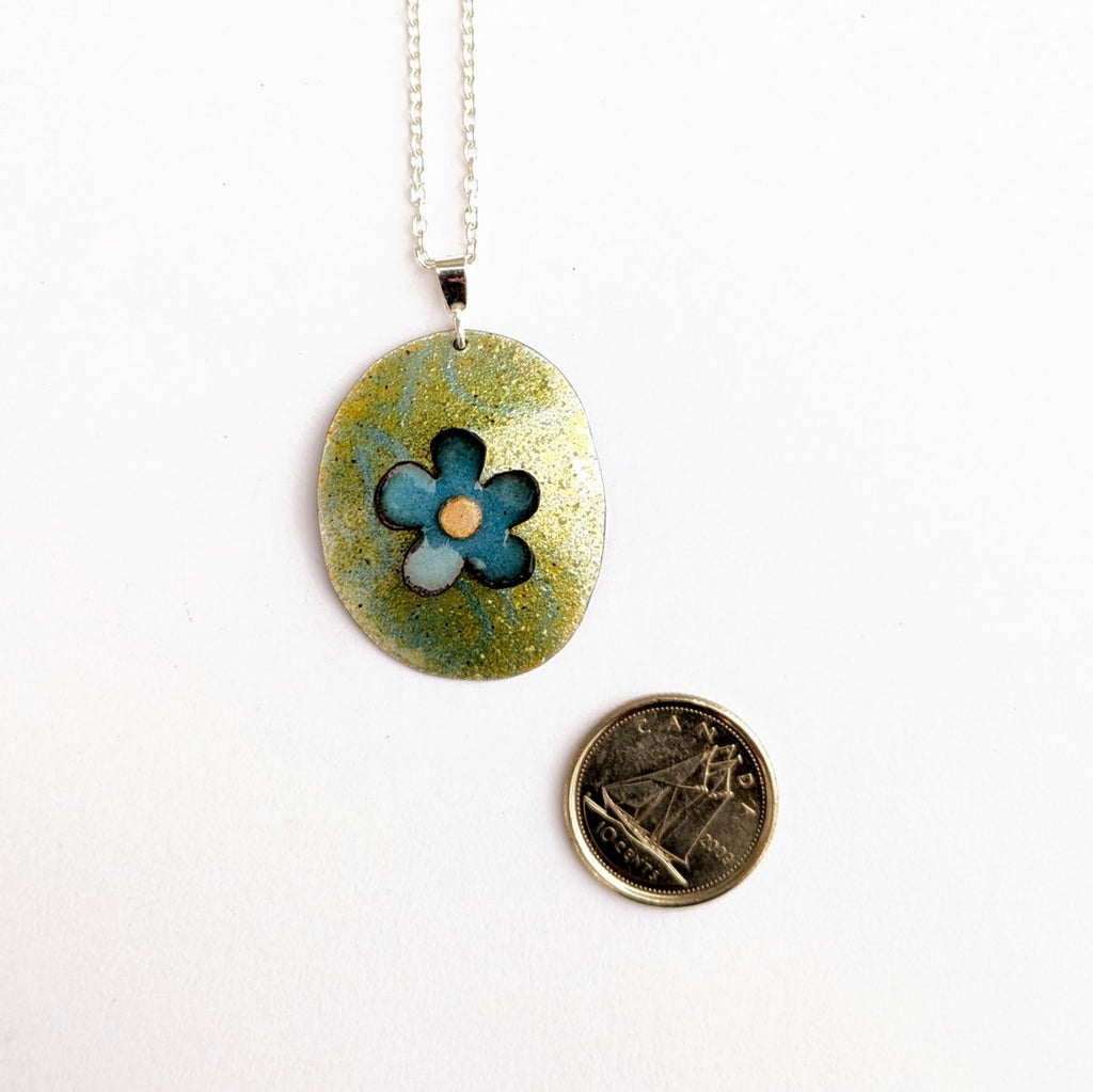 scale view of Floral domed pendant in enamel by Timothy Laurin, made in Canada