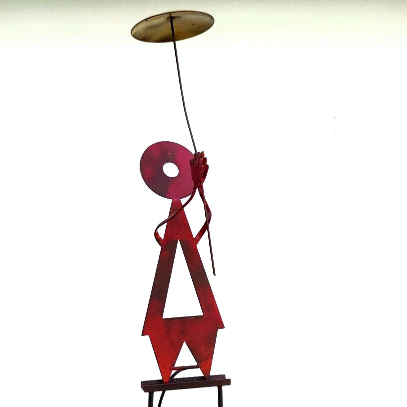 Detail of red balanced woman Kinetic sculpture by Mark Clark, steel and concrete