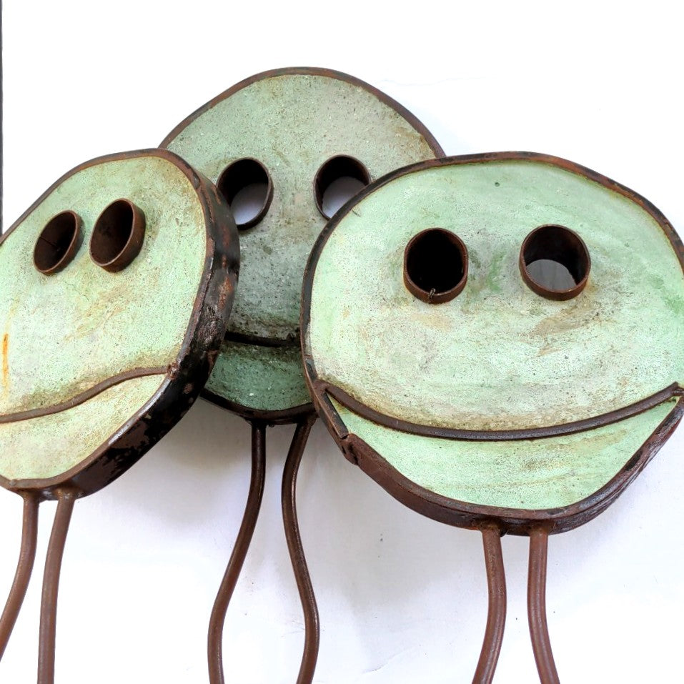 Green coloured Happy Pills by Mark Clark, steel and concrete sculpture.