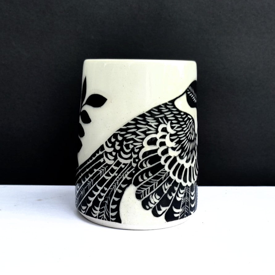 another view of bird design on White clay mug with carved black bird and branch design, pottery by Amanda Kerr