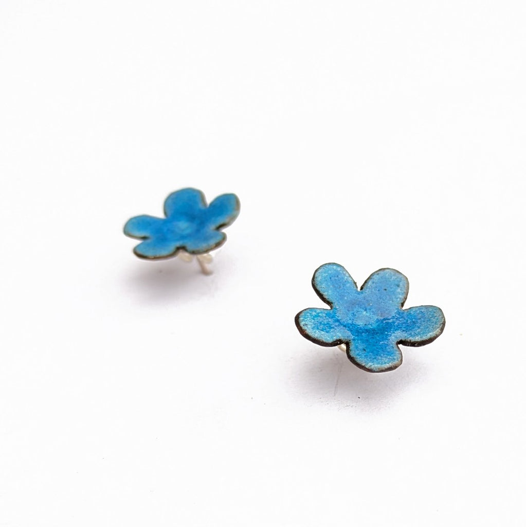 Blue enamel flower stud earrings by Timothy Laurin, handmade in Canada. side view