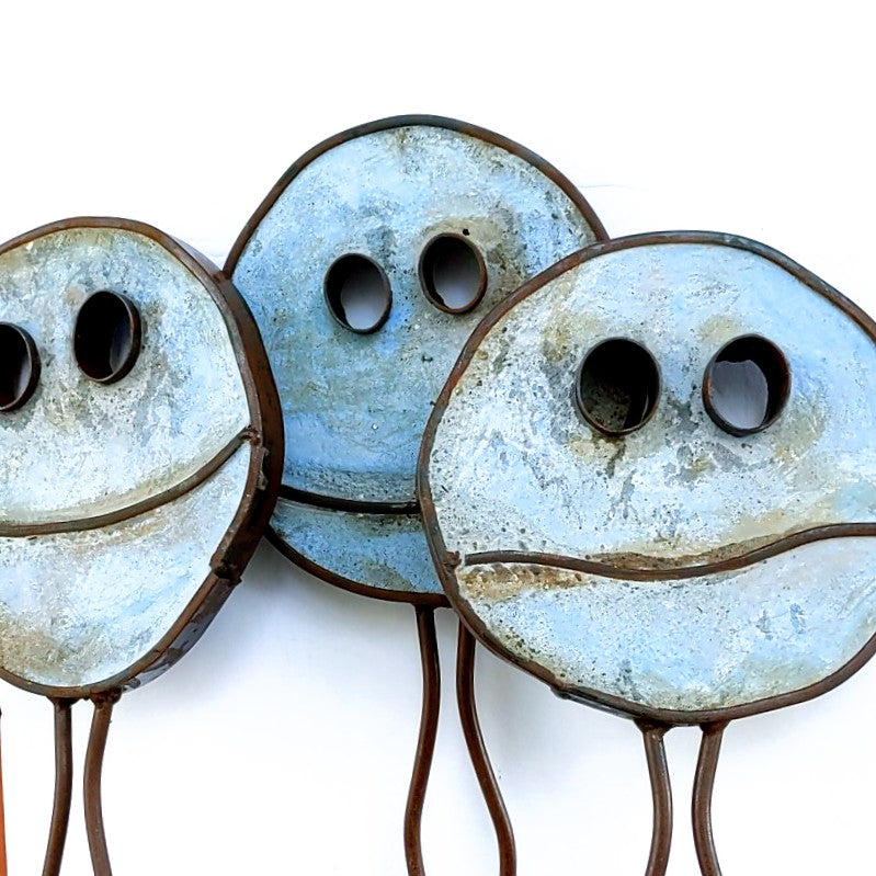 Blue coloured Happy Pills by Mark Clark, steel and concrete sculpture.