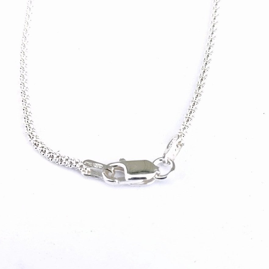 Sterling silver chain and lobster clasp included with this oblong stone pendant.