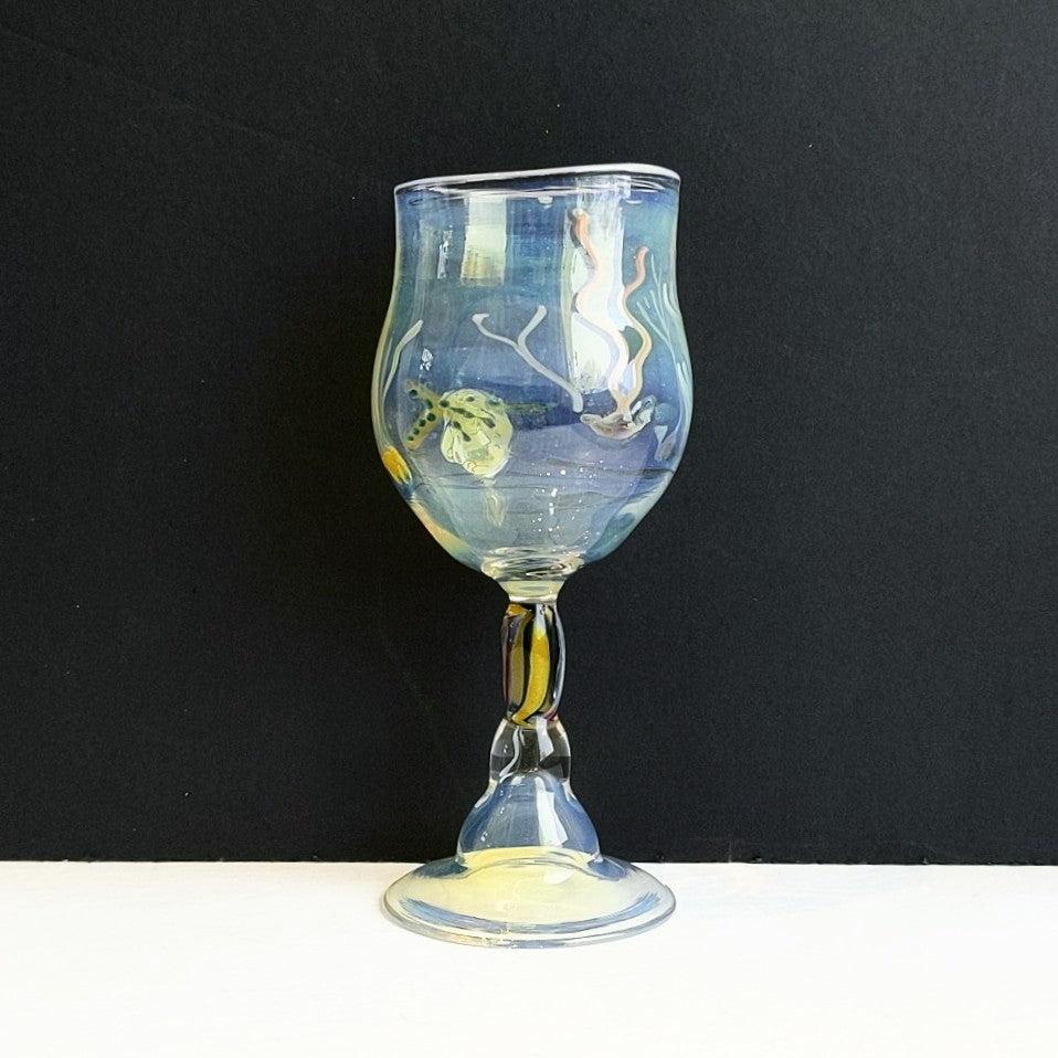 Starfish and seaweed on glass goblet by Otter Rotolante