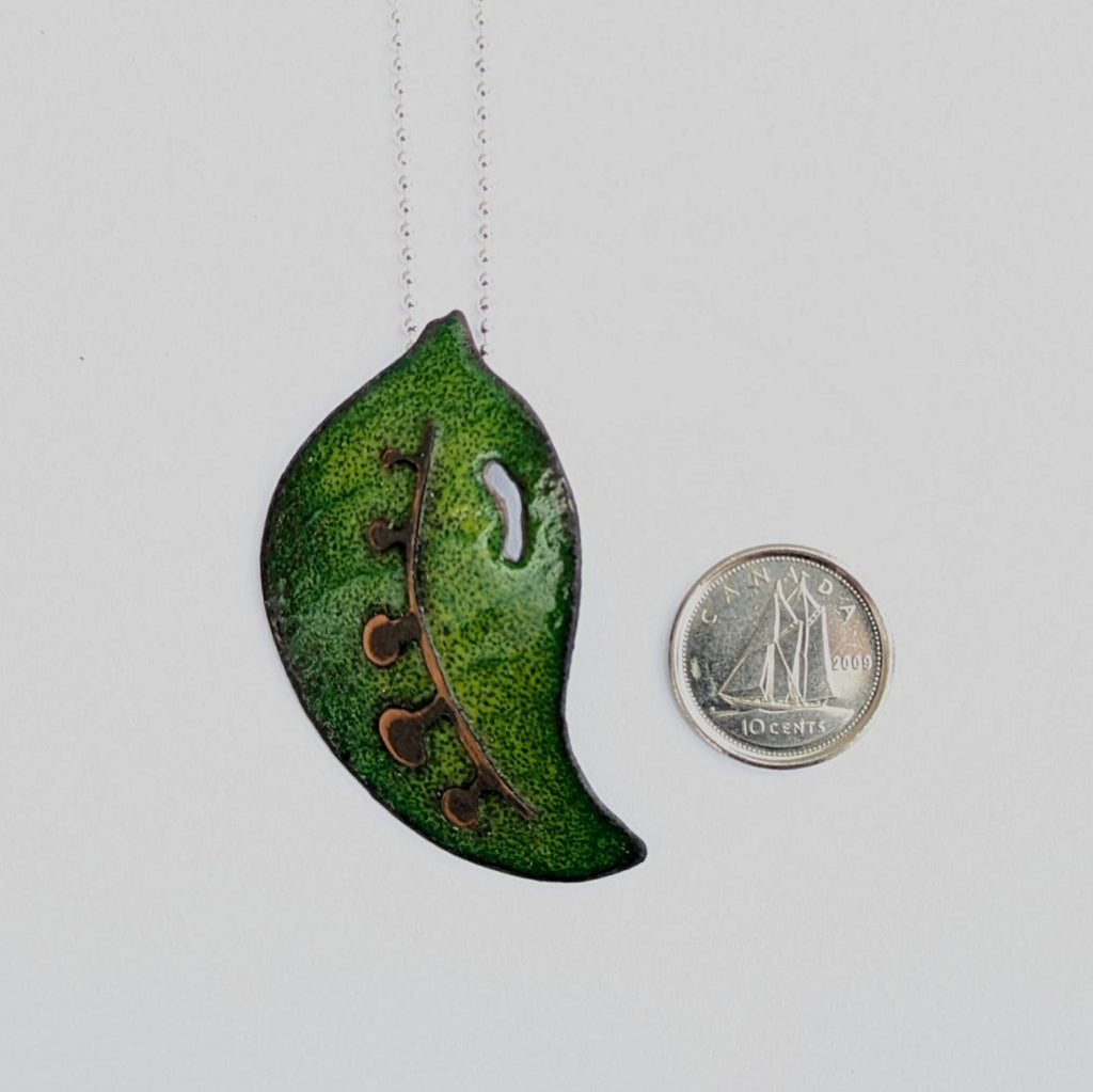 scale view of Green enamel leaf pendant, made in Canada by Tim Laurin