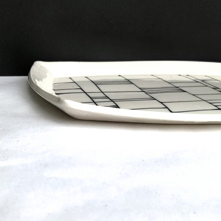 side view of Gridwork design, black and white serving platter, hand made pottery by Juliet Promintz