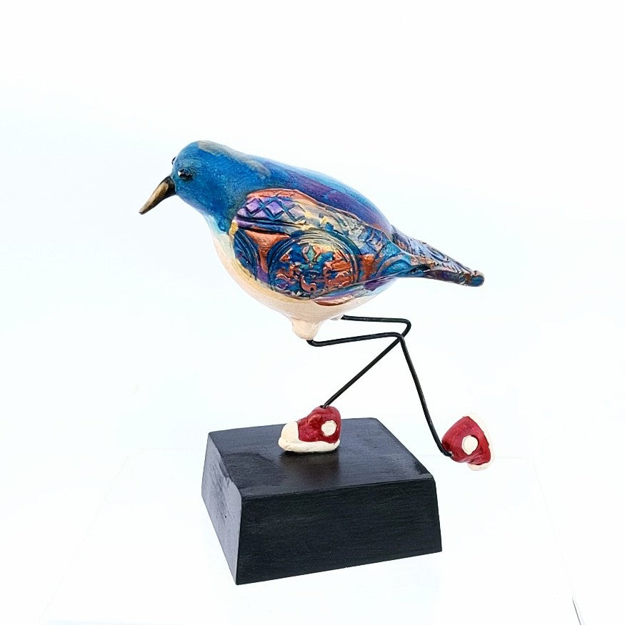 Baby Blue Bird with sneakers, ceramic sculpture by Steven  McGovney, side view