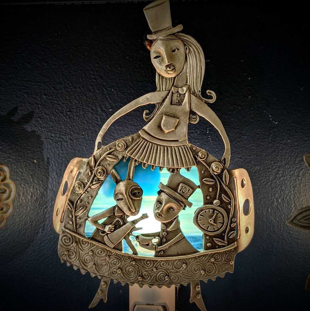 Alice's Tea Party pewter night light by Leandra Drumm, night view