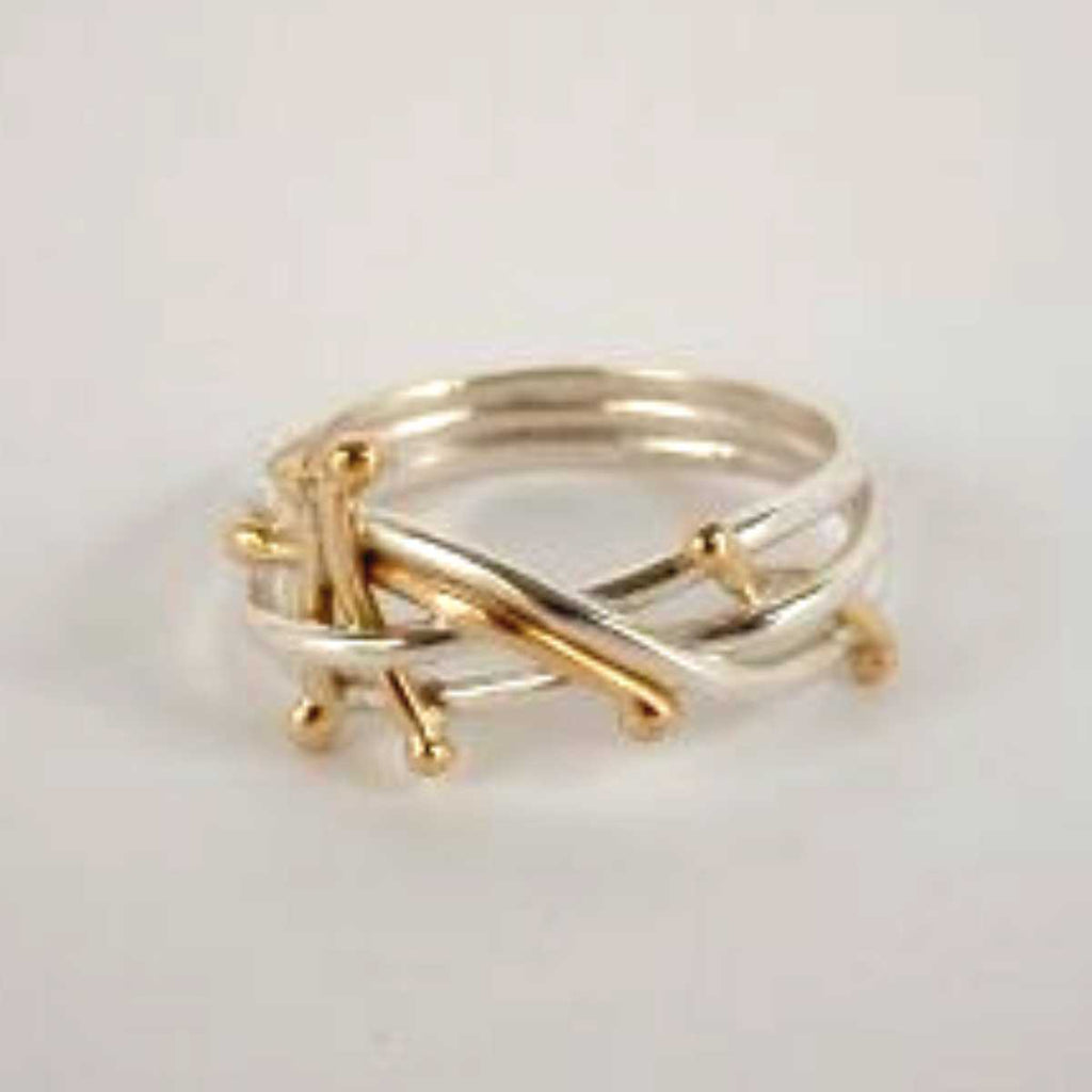 Sterling silver and 14 karat gold make up the twig-like network in this handcrafted ring by Lynda Constantine.